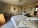 Cozy bedroom with a floral-patterned quilt, ceiling fan, and warm-toned walls at 5311 Palena Blvd, North Port, FL 34287