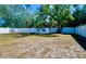 Spacious fenced backyard features lush trees, a storage shed, and room for outdoor activities at 5527 20Th W St, Bradenton, FL 34207