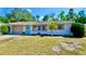 Charming single-story home with a manicured front lawn, a blue front door, and an attached garage at 5527 20Th W St, Bradenton, FL 34207