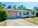 Charming single-story home with a manicured front lawn, a blue front door, and an attached garage at 5527 20Th W St, Bradenton, FL 34207