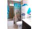 Bathroom with tub, toilet, and beach-themed shower curtain at 562 Longwood Dr, Venice, FL 34285