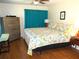 King-size bed, dresser, and teal curtains in spacious bedroom at 562 Longwood Dr, Venice, FL 34285