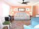 Living room with reclining sofa and ceiling fan at 562 Longwood Dr, Venice, FL 34285