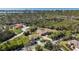 This aerial view showcases the home, detached garage, and a long winding driveway at 5694 Hale Rd, Venice, FL 34293