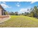 Expansive backyard with lush green lawn and tropical landscaping creating a serene outdoor oasis at 5694 Hale Rd, Venice, FL 34293