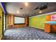 Entertainment room with projector screen, wet bar and custom carpeting at 5694 Hale Rd, Venice, FL 34293