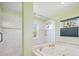 Bright bathroom featuring a soaking tub, glass shower enclosure, and tile work at 5694 Hale Rd, Venice, FL 34293