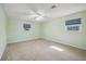 Bright bedroom with wall-to-wall carpet and natural light from two large windows at 5694 Hale Rd, Venice, FL 34293