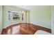 Inviting dining room with hardwood floors, chandelier, and large windows overlooking the front yard at 5694 Hale Rd, Venice, FL 34293