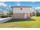 Exterior view of the two-story house shows a well-manicured lawn, and stairs at 5694 Hale Rd, Venice, FL 34293