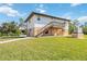 Exterior of a two story house features a deck, stairs and a grassy lawn area at 5694 Hale Rd, Venice, FL 34293