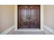 Elegant dark wood double front doors create a grand entrance to the home at 5694 Hale Rd, Venice, FL 34293