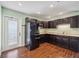 Kitchen with dark cabinetry, stainless steel appliances and door leading to the outside at 5694 Hale Rd, Venice, FL 34293