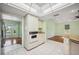 Bright kitchen with white cabinets, granite countertops, and a view into the adjacent living area at 5694 Hale Rd, Venice, FL 34293