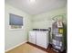 Bright laundry room features a window, washer, dryer, shelving, and a water heater at 5694 Hale Rd, Venice, FL 34293