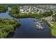 Aerial view featuring waterfront homes with docks, surrounded by lush greenery and a tranquil waterway at 590 Portside Dr, North Port, FL 34287