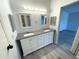 Bathroom featuring gray wood floors and a spacious double vanity with a granite countertop at 590 Portside Dr, North Port, FL 34287