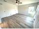 Spacious bedroom featuring gray wood floors, neutral white walls, and a ceiling fan at 590 Portside Dr, North Port, FL 34287