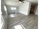 Bright bedroom with wood-look flooring, windows providing natural light and neutral paint tones at 590 Portside Dr, North Port, FL 34287