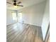 Bright bedroom featuring gray wood floors, neutral white walls and two bright windows at 590 Portside Dr, North Port, FL 34287