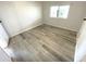 Empty bedroom featuring wood-look flooring and a window at 590 Portside Dr, North Port, FL 34287