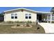 Attractive home featuring a well-kept lawn and a covered parking area at 590 Portside Dr, North Port, FL 34287