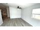 An empty living room with gray flooring, white walls, a ceiling fan and a bright window at 590 Portside Dr, North Port, FL 34287