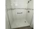 Beautifully tiled shower with two glass shelves and a grab bar at 590 Portside Dr, North Port, FL 34287