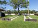 Outdoor shuffleboard courts with mature trees providing shade and green grass surrounding the courts at 590 Portside Dr, North Port, FL 34287