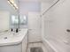 Bright bathroom featuring double mirrors, bathtub with shower, and tiled flooring at 595 Back Nine Dr, Venice, FL 34285