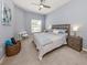 Bedroom featuring a ceiling fan, nightstand, and decorative wall art with cozy carpet at 595 Back Nine Dr, Venice, FL 34285