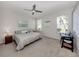 Bright bedroom featuring a ceiling fan and two windows at 595 Back Nine Dr, Venice, FL 34285