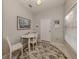 Bright breakfast nook featuring a white round table, three chairs, and an area rug at 595 Back Nine Dr, Venice, FL 34285