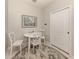 Breakfast nook featuring a round white table and a decorative round rug with a door on the right at 595 Back Nine Dr, Venice, FL 34285