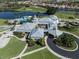 Aerial view of the community clubhouse featuring a pool, golf course, and lush landscaping at 595 Back Nine Dr, Venice, FL 34285