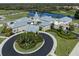 Attractive aerial view of clubhouse, beautiful landscaping, and convenient parking at 595 Back Nine Dr, Venice, FL 34285