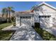 Charming home featuring a well-manicured lawn, a tile roof, and a two-car garage at 595 Back Nine Dr, Venice, FL 34285