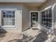 Inviting front entrance with a covered porch, decorative windows, and a stylish front door at 595 Back Nine Dr, Venice, FL 34285