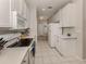 Well lit kitchen featuring white appliances and white countertops with tiled floor at 595 Back Nine Dr, Venice, FL 34285