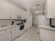 Well lit kitchen featuring white countertops, stainless steel appliances, and tiled floor at 595 Back Nine Dr, Venice, FL 34285