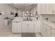 Kitchen featuring white cabinetry, stainless steel appliances, and views of living area at 595 Back Nine Dr, Venice, FL 34285