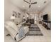 Bright living room featuring tile flooring, ceiling fan, and neutral color palette with multiple sofas at 595 Back Nine Dr, Venice, FL 34285