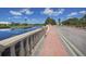 Scenic street with red brick sidewalks, a bridge, and a serene lake view at 595 Back Nine Dr, Venice, FL 34285