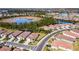 Aerial view of houses and a pond in a residential area at 600 Nasturtium Ct, Nokomis, FL 34275