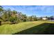 Large grassy backyard with a black metal fence at 600 Nasturtium Ct, Nokomis, FL 34275