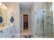 Bathroom features a walk-in shower, double vanity, and marble flooring at 600 Nasturtium Ct, Nokomis, FL 34275