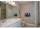 Bathroom with double sinks, a large mirror, and neutral colors at 600 Nasturtium Ct, Nokomis, FL 34275