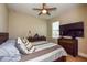 Bedroom with a full-size bed, mounted TV, and space-themed decor at 600 Nasturtium Ct, Nokomis, FL 34275