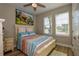 Guest bedroom with a queen-size bed and coastal decor at 600 Nasturtium Ct, Nokomis, FL 34275