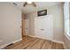 Well-lit bedroom with double doors and wood-look flooring at 600 Nasturtium Ct, Nokomis, FL 34275